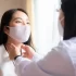 A thyroid specialist examining the patient’s throat condition