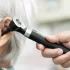 ENT Specialist in Singapore Using Otoscope to Check the Ear of Woman